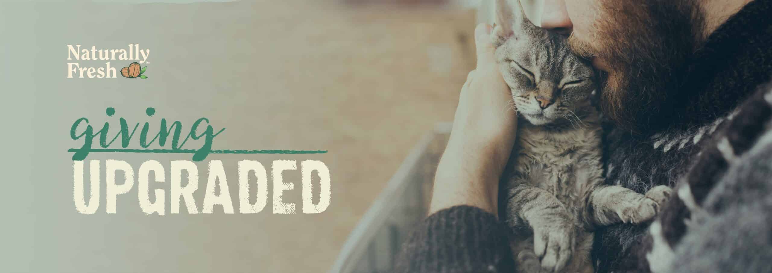 An ad for Naturally Fresh cat litter featuring a bearded man cuddling with a cat