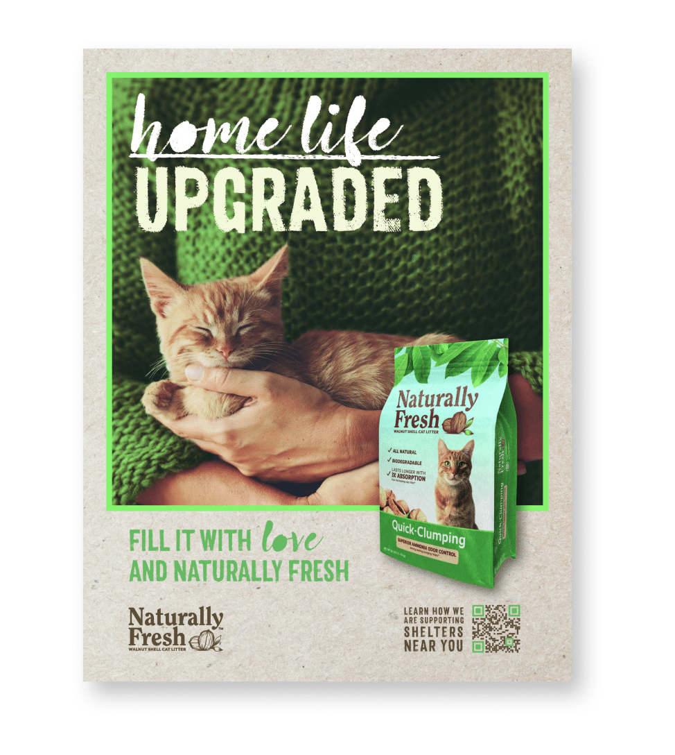 An ad for Naturally Fresh cat litter featuring someone in a sweater holding an orange cat