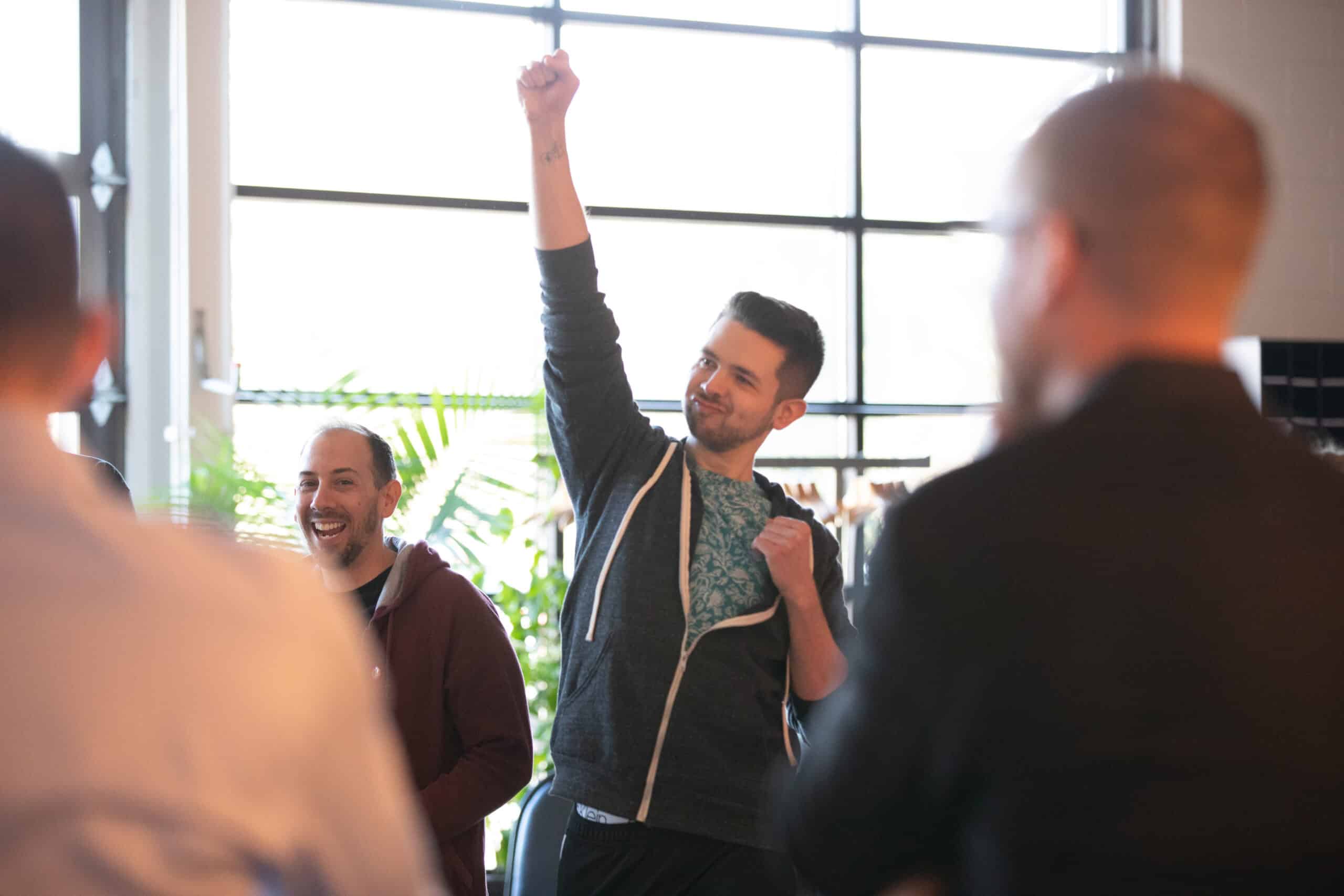 A Pathfinders team member raising his fist in celebration